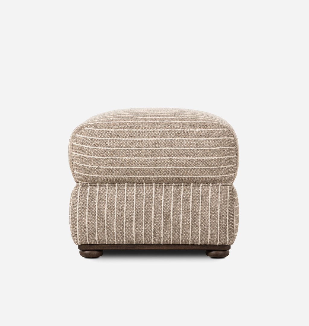 A square upholstered ottoman with a beige and white striped pattern, supported by dark brown wooden legs, shown against a plain white background.