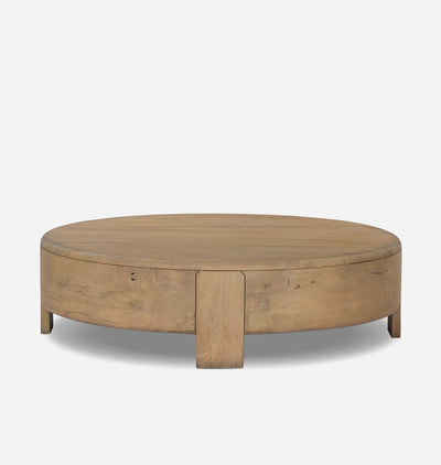 A round wooden coffee table with a natural oak finish, featuring a central pedestal leg and visible wood grain, set against a plain light gray background.