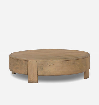 A round wooden coffee table with a natural oak finish, featuring a thick circular top and block-style legs, shown against a plain light gray background.