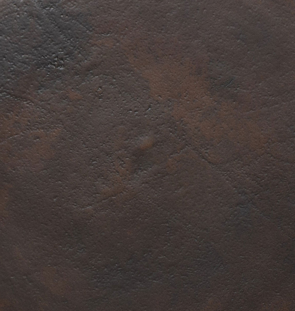 A close-up texture shot of a dark brown metal material with subtle mottled variations and a fine grain.