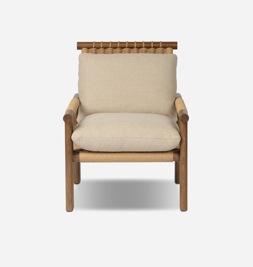 A modern outdoor armchair with a natural wood frame, woven rope details, and thick beige linen cushions, shown against a light gray background.