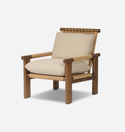 A modern outdoor armchair featuring a warm brown wooden frame, woven rope details, and thick beige cushions, shown against a light gray background.