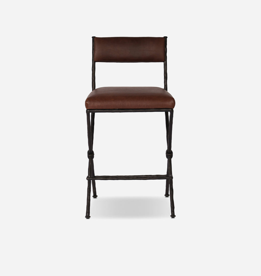A mid-century modern counter stool with a brown leather upholstered seat and backrest, supported by a black metal frame with knolled leg details, shown against a light gray background.