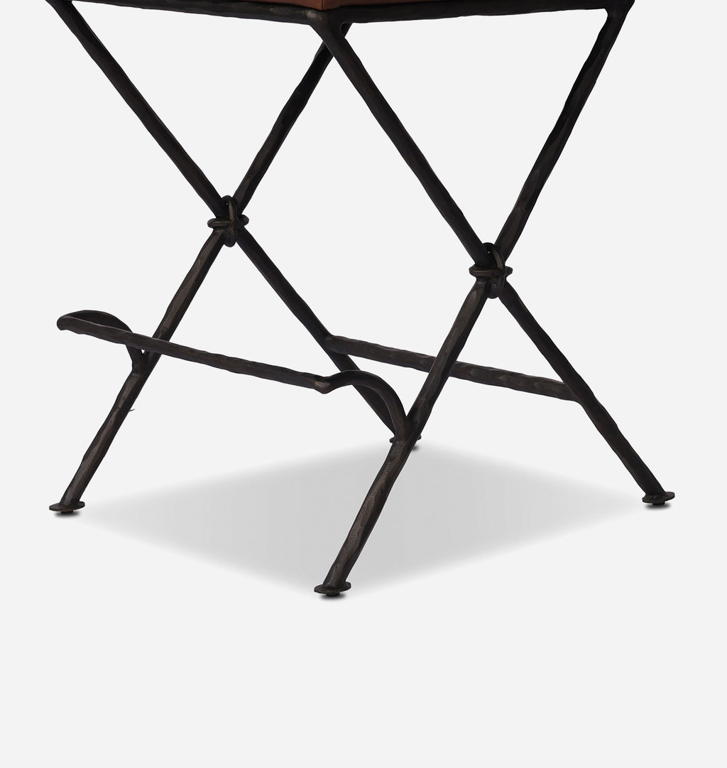 Close-up of a dark metal folding table leg frame on a light gray background.