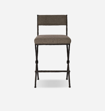 A modern counter stool with a textured taupe-brown upholstered seat and backrest, supported by a dark metal frame with knolled legs and a footrest, shown against a light gray background.