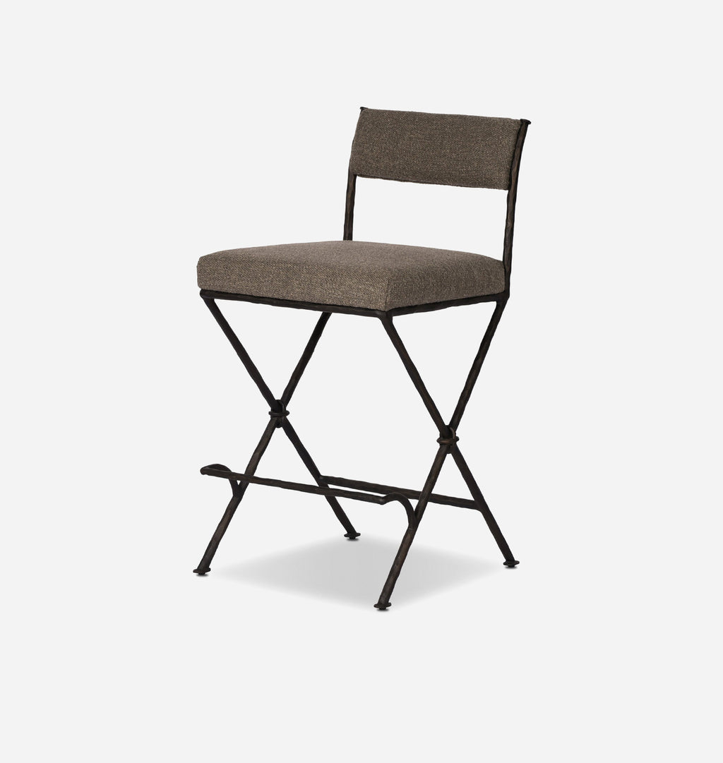 A modern folding bar stool with a textured taupe-brown upholstered seat and backrest, supported by a black metal frame with a footrest.