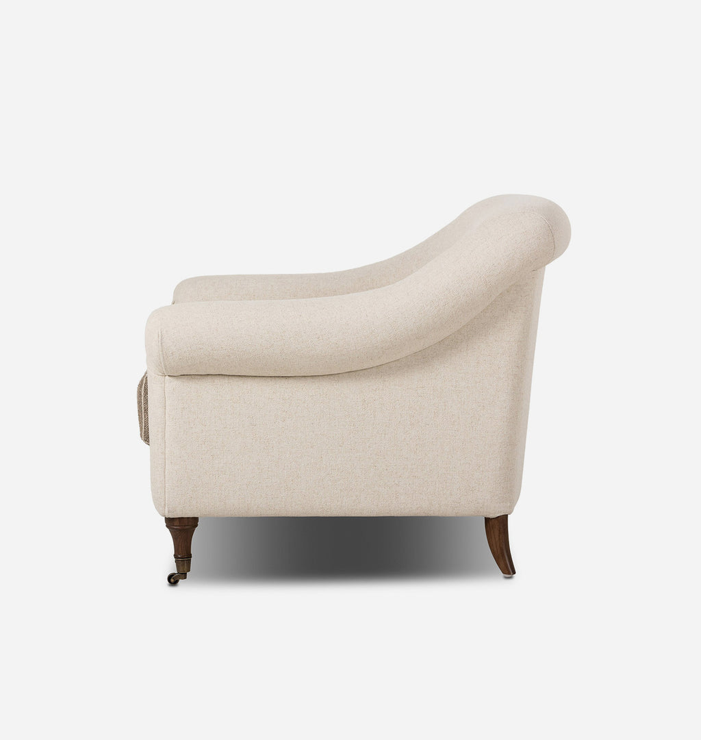 A classic armchair upholstered in a warm cream fabric with a striped brown and beige seat cushion, supported by dark brown wooden legs, shown against a plain white background.