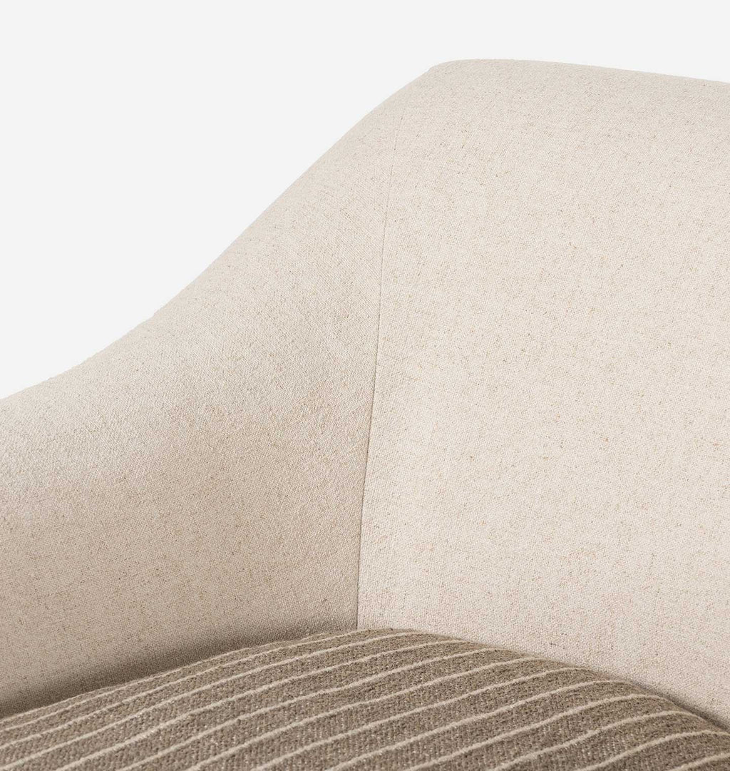 Close-up of a beige upholstered chair or sofa arm with a textured woven seat cushion showing taupe and cream striped fabric.