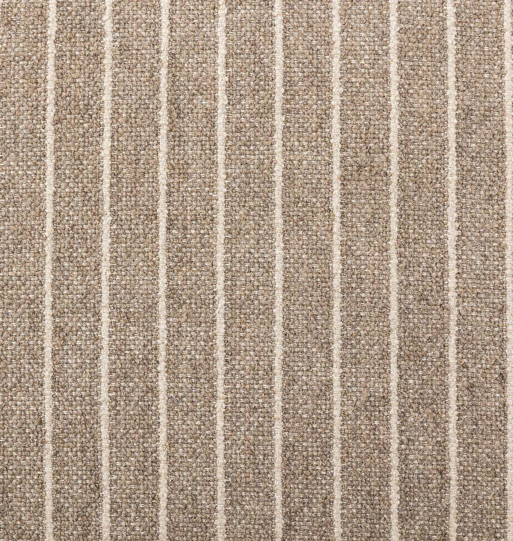 A close-up of a woven fabric or rug texture with vertical pinstripes in warm taupe and off-white.