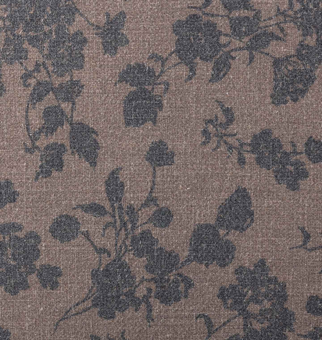 A vintage-style upholstery with a dusty mauve and navy floral pattern 