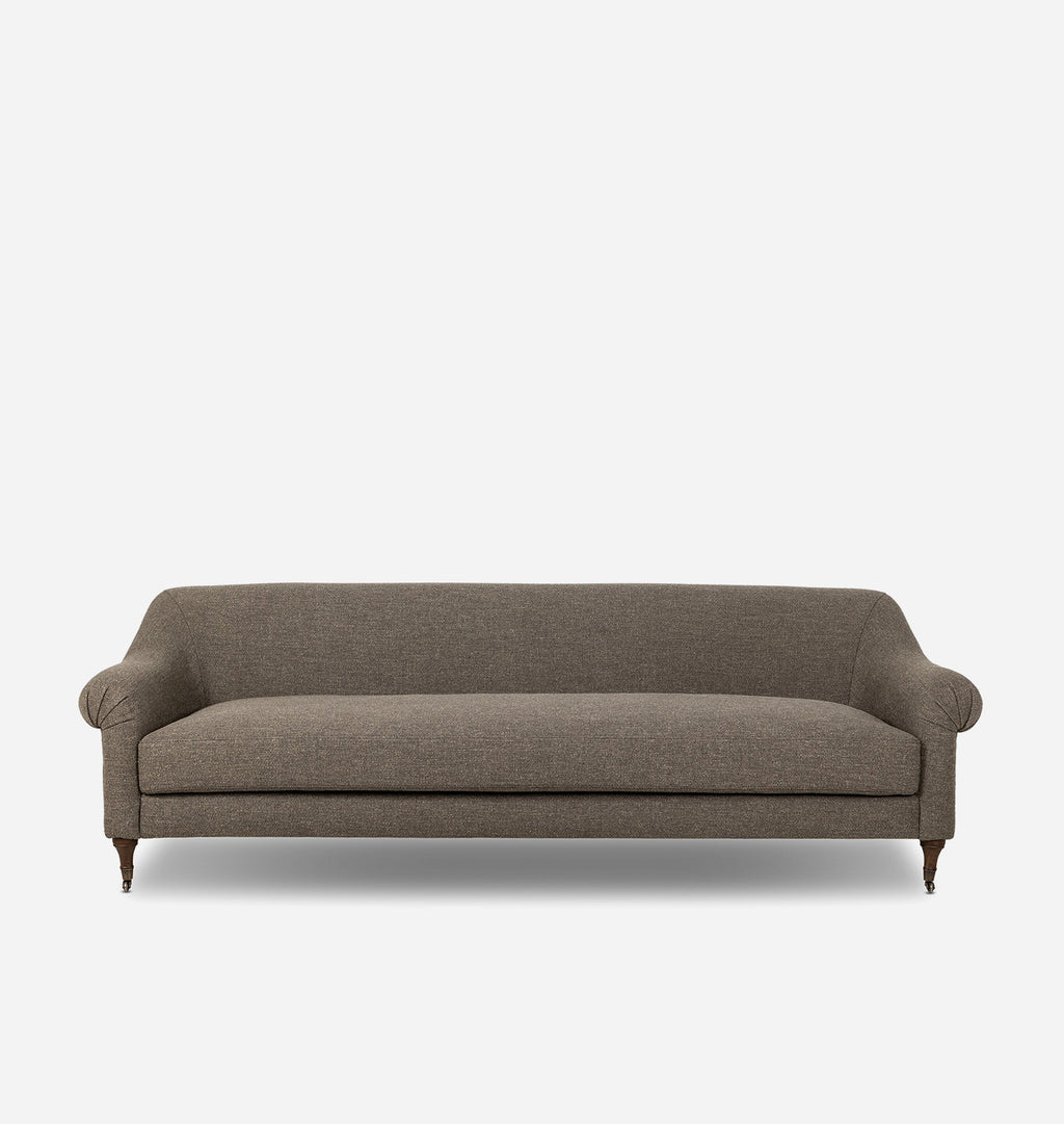 A classic three-seater sofa upholstered in textured taupe fabric, featuring rolled arms, a thick seat cushion, and dark wooden legs, shown against a plain light gray background.