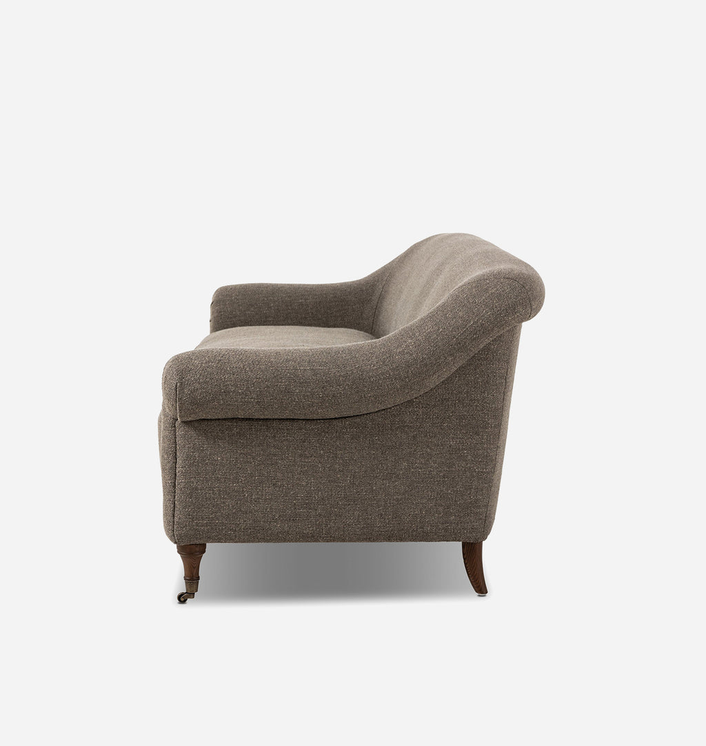 A classic armchair upholstered in textured taupe fabric with dark brown wooden legs, shown from a three-quarters angle against a plain white background.