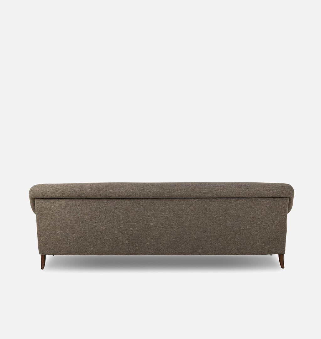 A low upholstered bench with a tufted backrest and short dark legs, shown from the front on a plain light gray background.