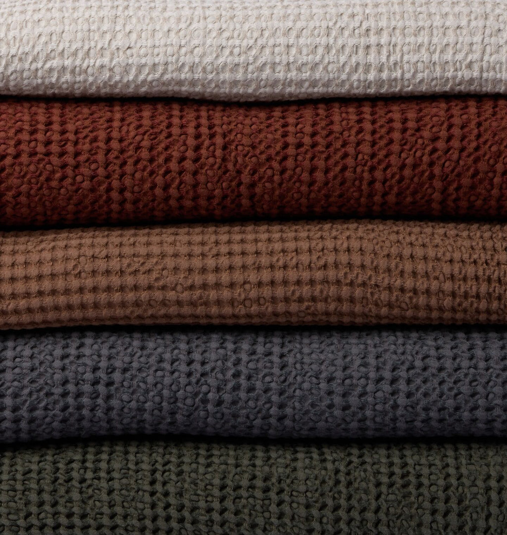 Close up of waffle weave blankets stacked ontop of eachother 