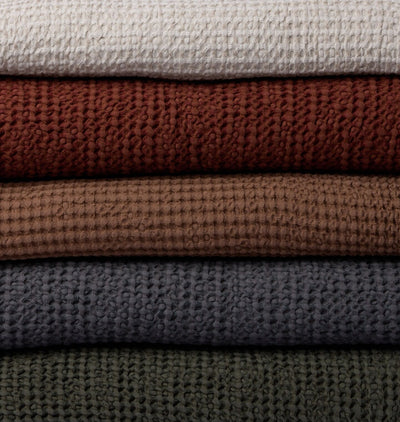 Close up of waffle weave blankets stacked ontop of eachother 