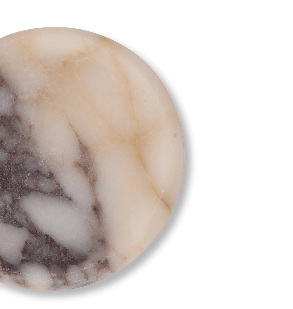 A close up of  a calacatta viola marble coaster with light grey and violet veining set against a white background.