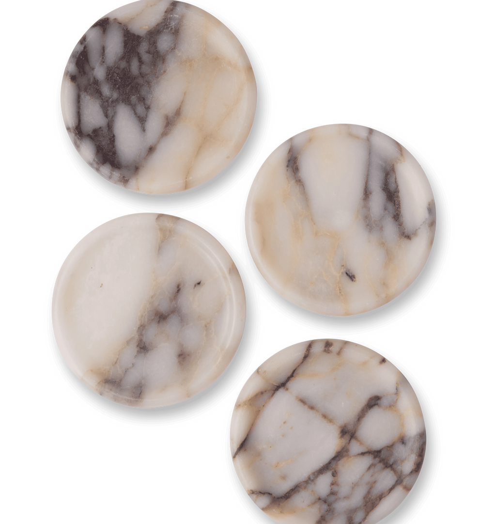 A set of calacatta viola marble coasters with light grey and violet veining set against a white background.