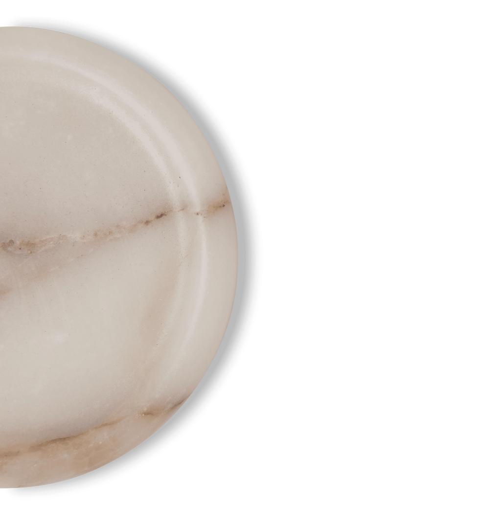 A white marble coasters with light grey and gold veining set against a white background. 