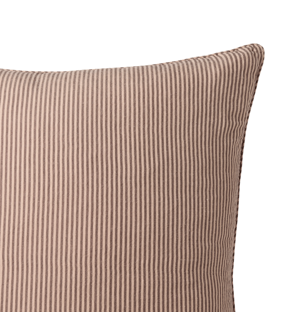 A striped pillow detail shot against a white background 