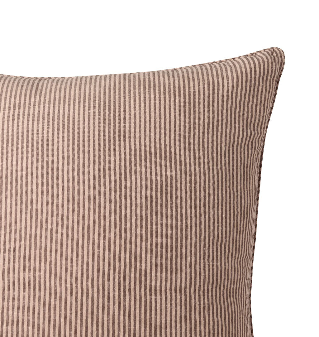 A striped pillow detail shot against a white background 